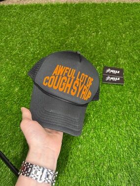 Black Trucker Hat with Orange 'Awful Lot of Cough Syrup' Lettering